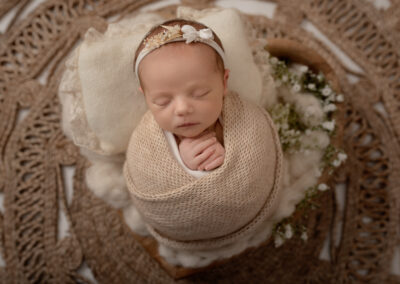 newborn baby girl with flowers in a heart