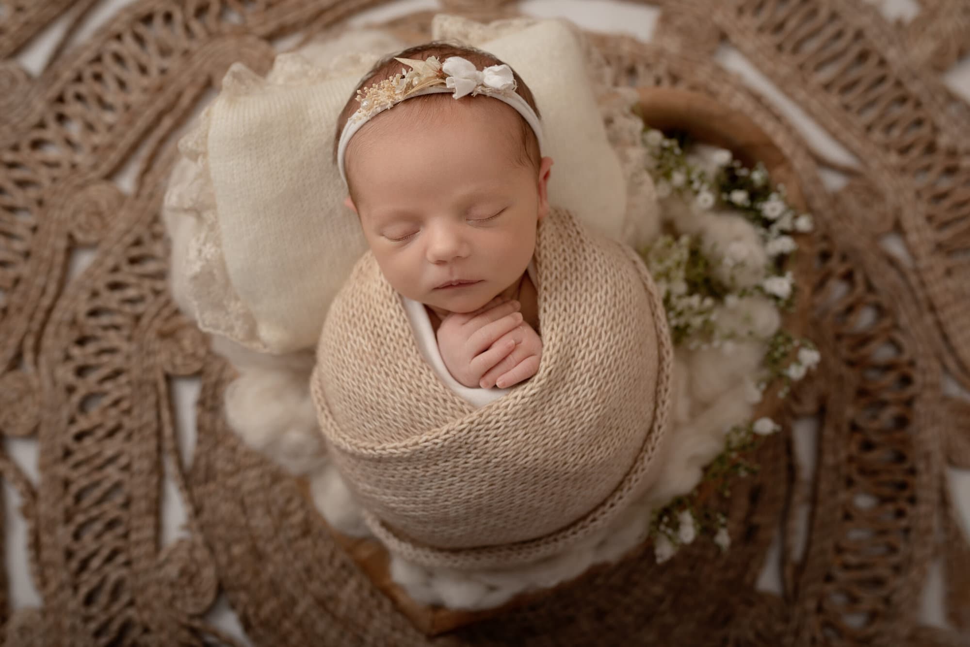 newborn baby girl with flowers in a heart